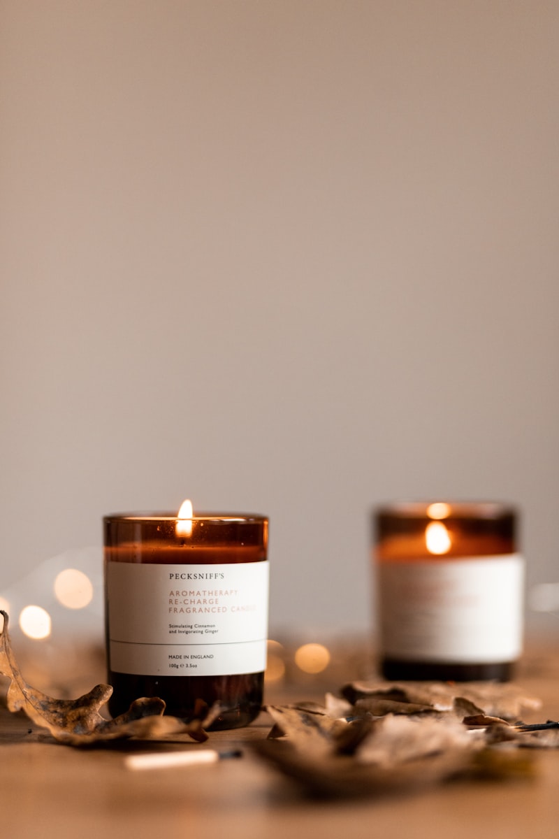 Glass jar candle providing home fragrance in cozy setting